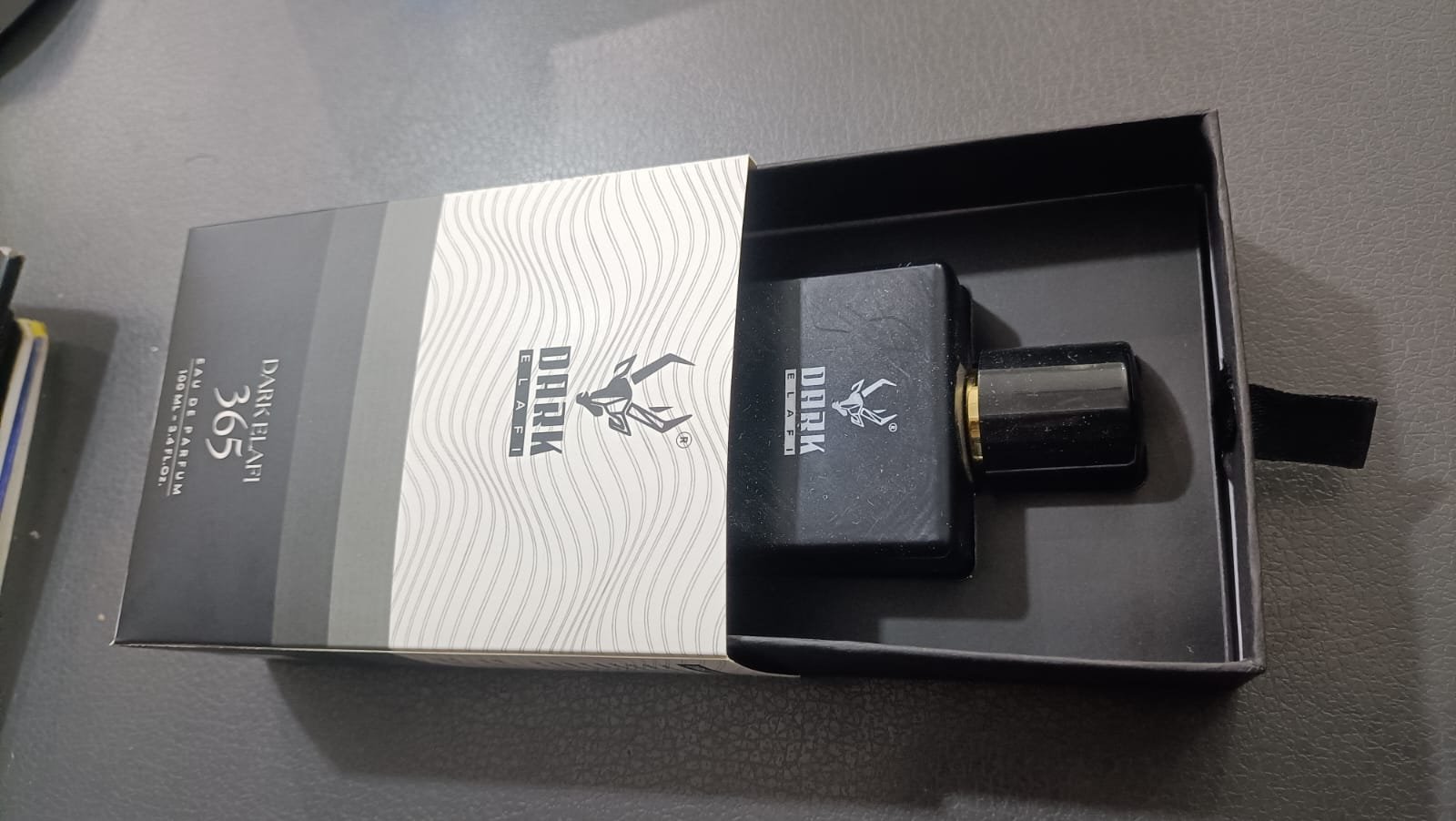 Sliding perfume carton with printed sleeve