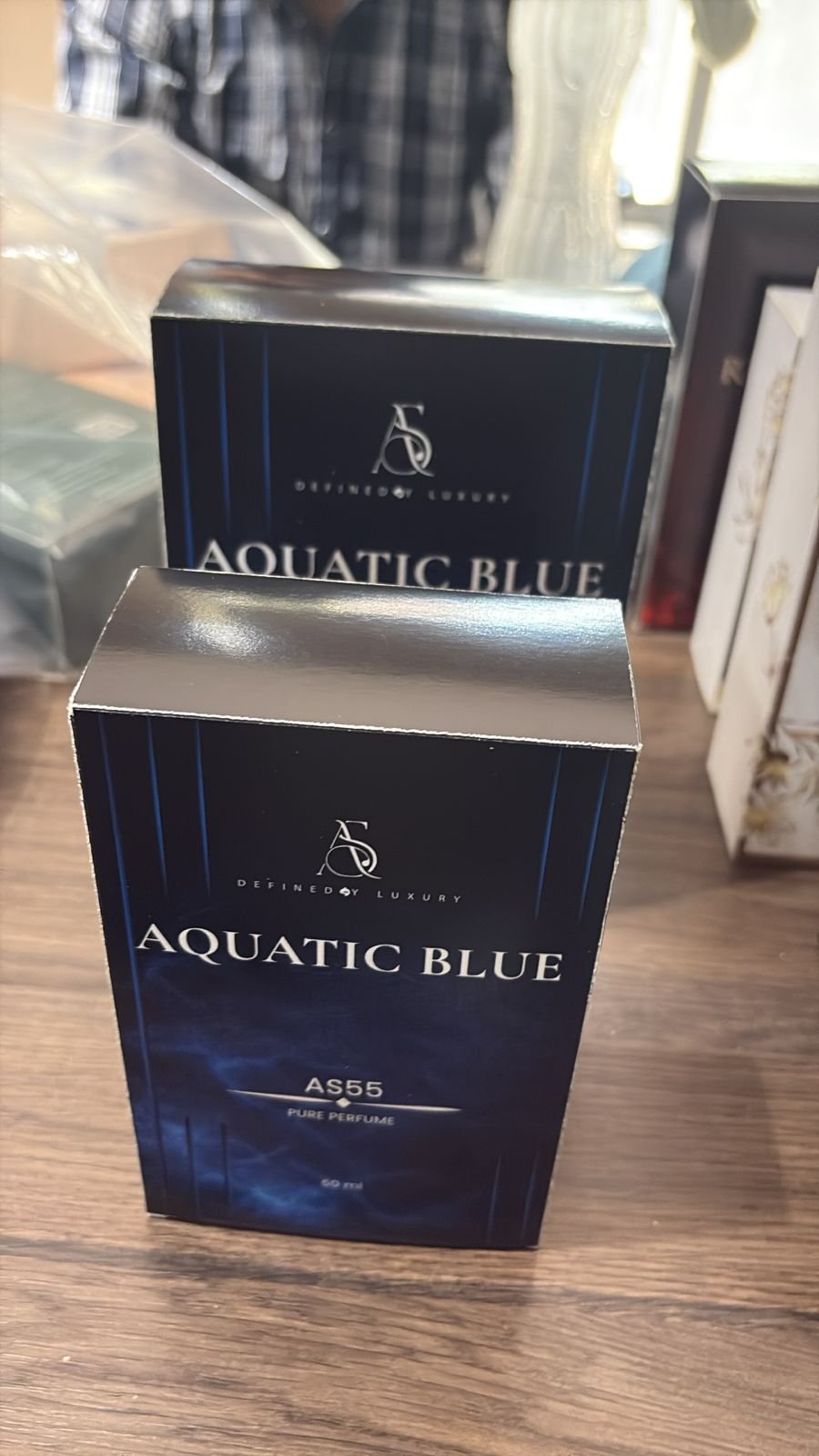 Blue perfume cartons with metallic top