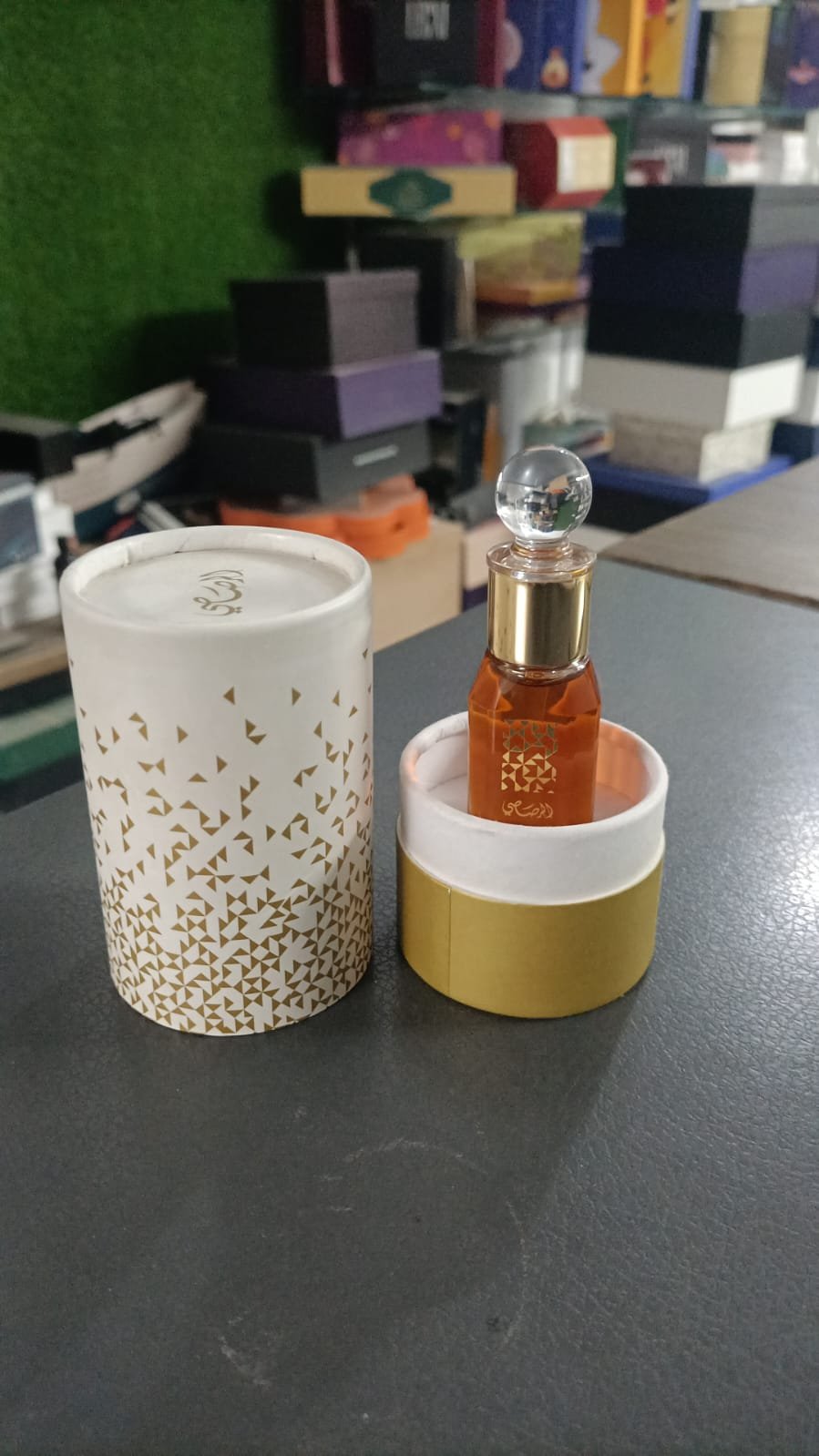 White and gold cylindrical fragrance box